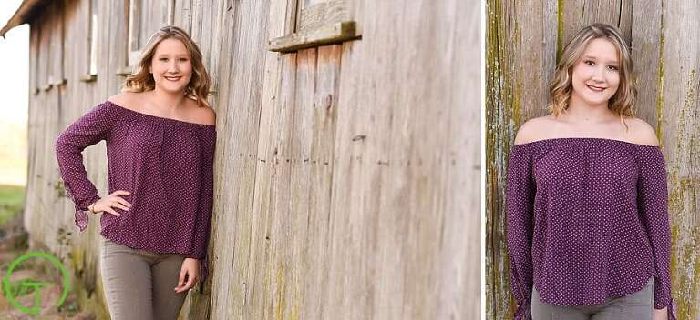 A high school senior poses for her Ypsilanti senior portrait session near an old rustic barn