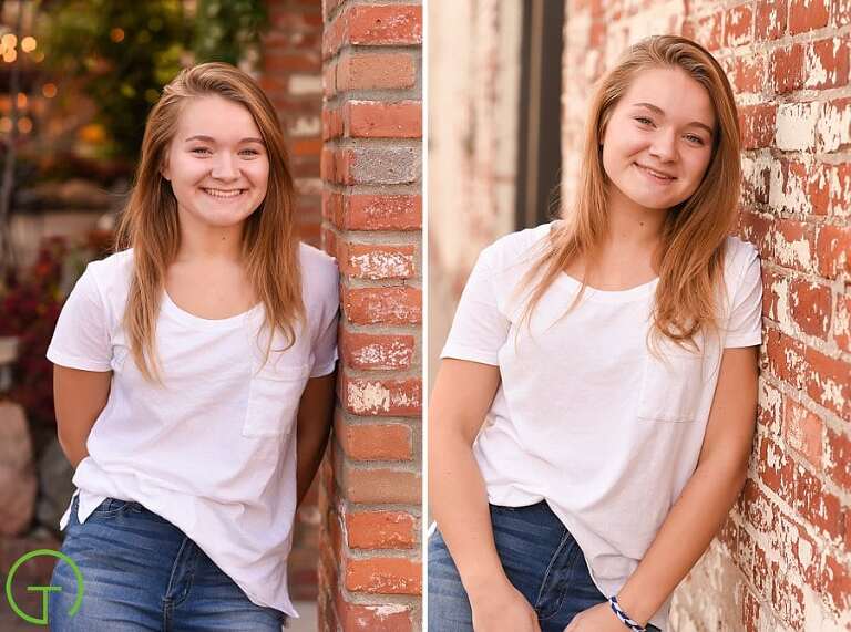 A high school senior poses near an old red brick building in Ann Arbor's Kerrytown during her senior portrait session