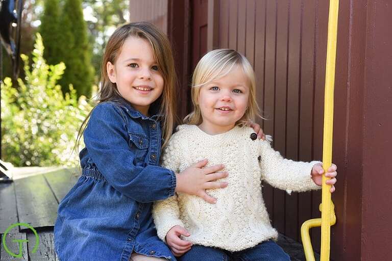 Two sisters happily pose on Ypsilanti's historic caboose