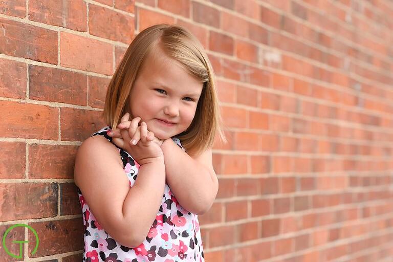 a child playfully poses near ypsilanti's historic freighthouse