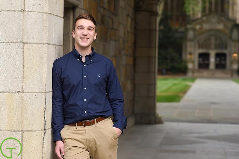 A high school senior poses at ann arbor's law quad