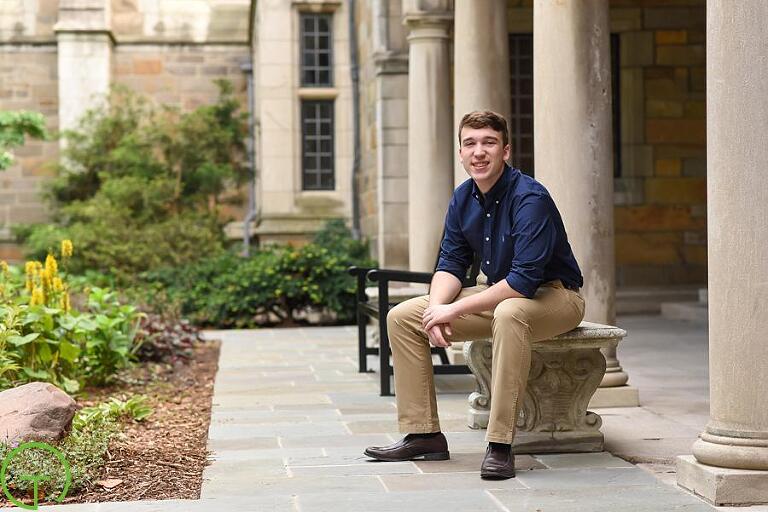 A high school senior sits on a bench at ann arbor's law quad