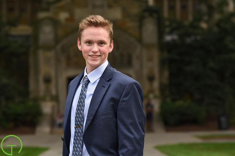 An Ann Arbor High School senior poses for his portrait session at the historic University of Michigan Law Qaud