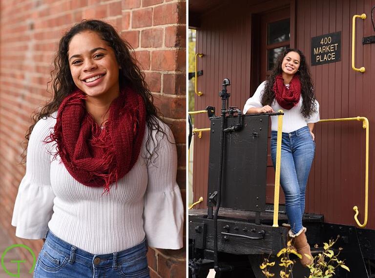 A high school senior poses near Ypsilanti’s Freighthouse in Depot Town during her Ypsilanti senior portrait session