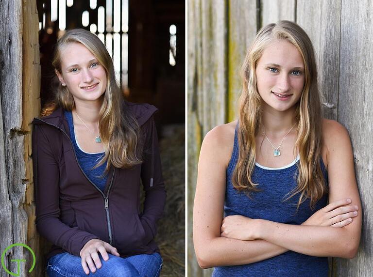 A high school senior poses near an old barn for her senior portrait session