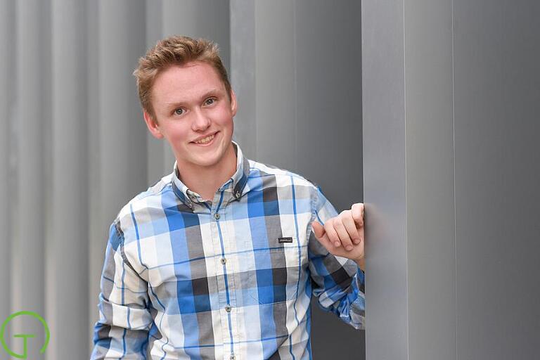 A high school senior poses near University of Michigan’s Museum of Art for his Ann Arbor Senior portrait session