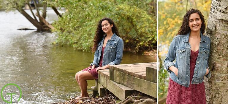 A teenager sits near the Huron River for her senior portrait session in Ann Arbor