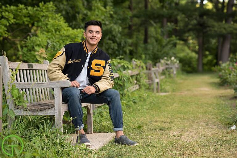 a senior boy wearing a varsity jacket - a perfect senior picture outfit idea