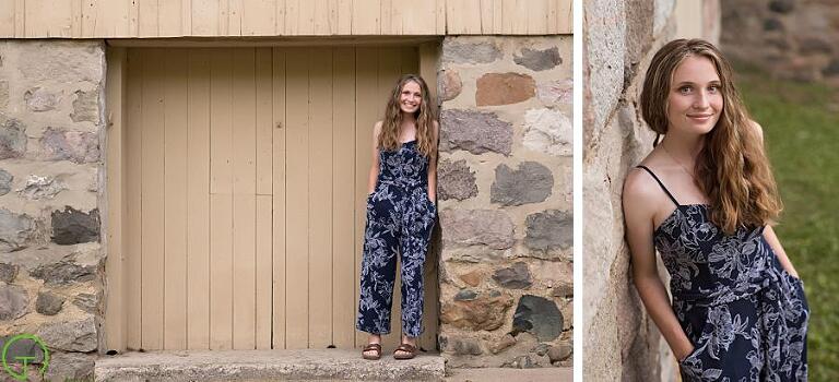 a high school senior poses near the parker mill barn for a portrait