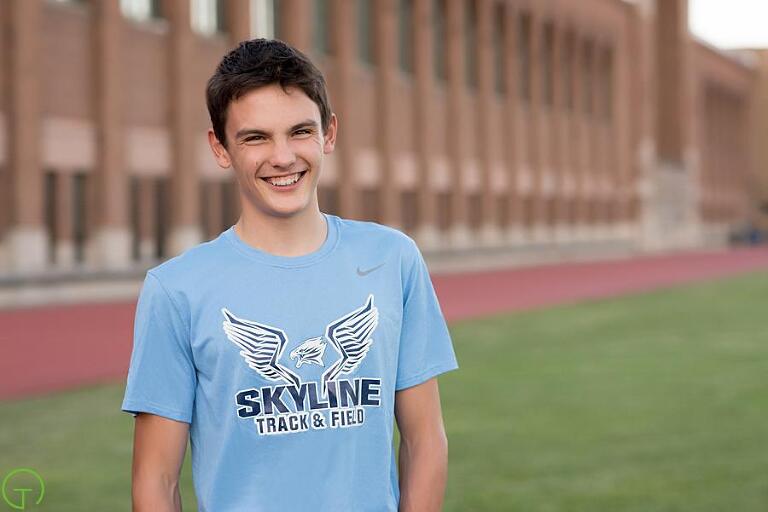 a high school senior track athlete poses in Ferry Field for a senior picture